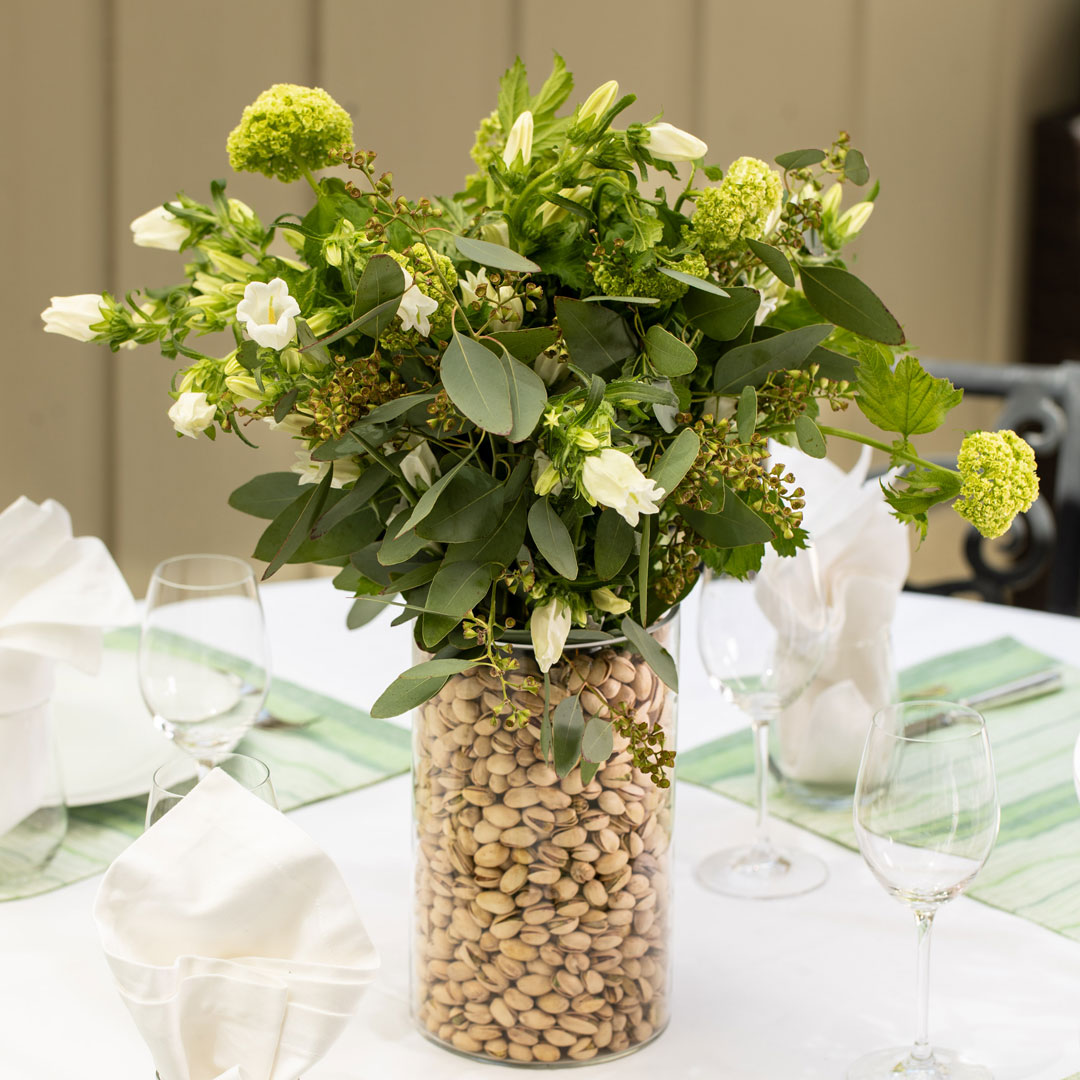 Vase filled with pistachios centerpiece